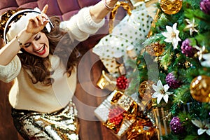 Happy trendy woman listening to music and dancing