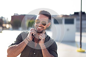 Happy trendy young caucasian man outdoors portrait