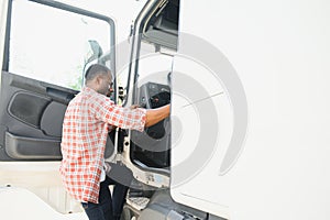 Happy truck driver entering in vehicle cabin.