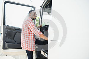 Happy truck driver entering in vehicle cabin.