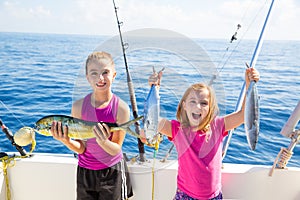 Happy tuna fisherwomen kid girls with fishes catch photo