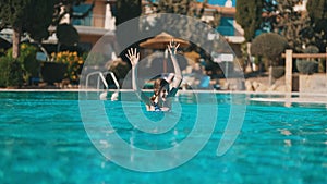 Happy tween girl in swimming pool.