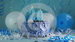 Happy twentieth birthday navy cake and number twenty candle with blue balloons