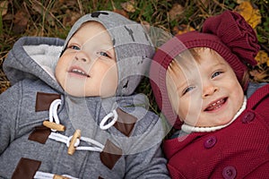 Happy twins in autumn park