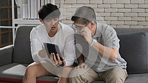 Happy two age generations asian men family old father embracing young adult son having fun