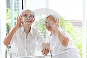 Happy two asian senior women showing ok sign with hand and fingers together,excellent symbol,friends of elderly woman or sister