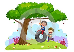 Happy two boys playing tire swing under the tree photo