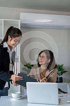 Happy two business woman account discussing documents financial result project overview at office meeting, Executives photo