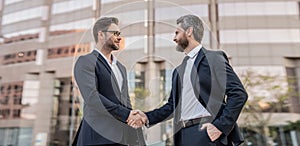 happy two businessmen in suit deal with handshake. photo of two businessmen deal with handshake