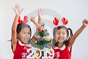 Happy two cute asian child girls with numbers 2019