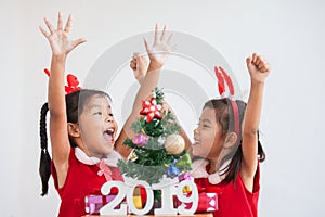 Happy two cute asian child girls with numbers 2019