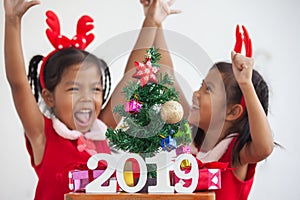 Happy two cute asian child girls with numbers 2019