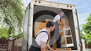 Happy two delivery men in front of delivery truck, Delivery men checking order of moving service