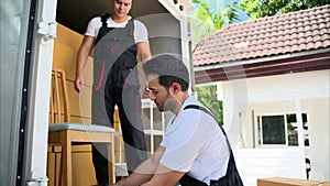 Happy two delivery men in front of delivery truck, Delivery men checking order of moving service