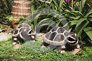 Happy two turtle doll made from stucco decoration in a garden