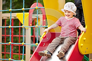 Happy two-year child on slide