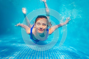 Happy underwater swim pool portrait of girl dive
