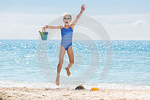 Happy vacation girl jump at sea beach