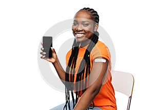 happy vaccinated woman and smartphone