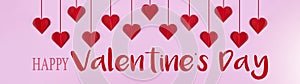 Happy Valentine`s Day background banner panorama greeting card template - Red hanging hearts isolated on pink paper texture