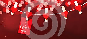 Happy Valentine`s Day background banner panorama long - White paper note hang on wooden clothes pegs with wooden hearts on a