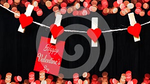 Happy Valentine`s Day background banner - White paper note hang on wooden clothes pegs with wooden hearts on a string isolated on