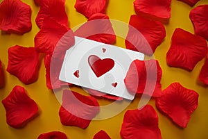 Happy Valentine's Day card with red rose petals sprinkled.