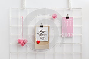 Happy Valentine`s Day card on a wall grid organizer.