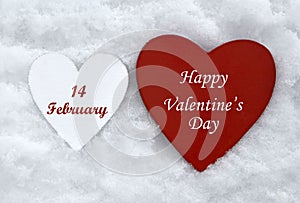 Happy Valentine`s Day greeting card.Holiday Valentine decoration.Two wooden hearts on natural white snow background.