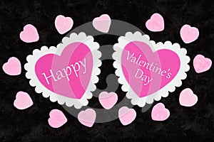 Happy Valentine`s Day greeting with white and pink hearts and candy hearts on black