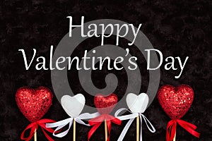 Happy Valentine`s Day greeting with white and red hearts on black