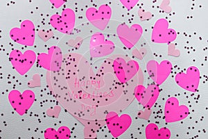 `Happy Valentine`s Day` message on a big pink hart with a lot of pink harts and sparkles around it