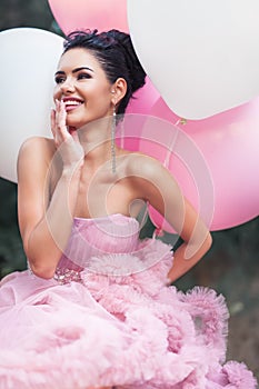 Happy Valentine`s day, portrait of fashion woman dressed in pink stunning dress