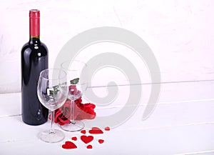 Happy Valentine`s Day with red wine, red roses, wine glasses and hearts in love