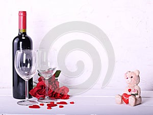 Happy Valentine`s Day with red wine, red roses, wine glasses and hearts in love