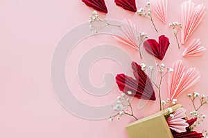 Happy Valentine\'s day ! Stylish pink and red hearts, flowers and gift box flat lay on pink background, space for text