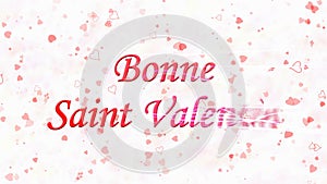 Happy Valentine's Day text in French Bonne Saint Valentin turns to dust from right on light background
