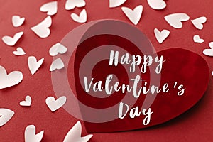 Happy Valentine`s Day text on stylish hearts on red background. Happy Valentines Day greeting card. Be my Valentine. Love concept