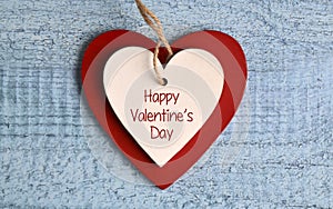 Happy Valentine`s Day.Two wooden hearts on on a blue background.St.Valentine Day greeting card.Love,romantic or wedding concept.