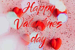 Happy valentine's day text on blurry Pink Background with Hearts.