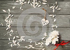 Happy Valentines Day background. Decorative white wooden heart on grey rustic, whith flowers, Valentine`s concept.