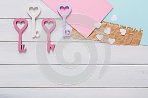 Happy Valentines Day background, key hearts. Copy space on wood