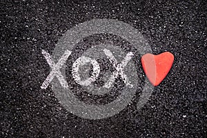 Happy Valentines day card, xoxo on the ground and heart stone