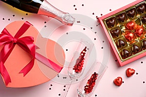 Happy Valentines day celebration concept. Flat lay composition with heart shaped box decorated red ribbon bow, sweets, wine and