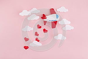 Happy Valentines day. Children`s plane on a pink background with red heart and white clouds