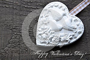 Happy Valentines Day.Decorative white heart on rustic wooden background.Valentine heart.Valentine`s Day or Love concept.