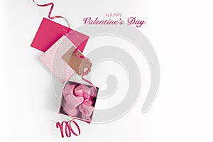 Happy Valentines Day. Gift box with pink chocolate hearts  greeting card and ribbon.