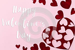 Happy Valentines Day greeting card. Happy Valentine`s Day text on stylish red hearts on pink background. Be my Valentine. Love