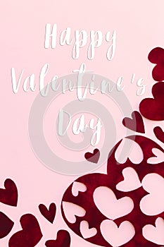 Happy Valentines Day greeting card. Happy Valentine`s Day text on stylish red hearts on pink background. Be my Valentine. Love