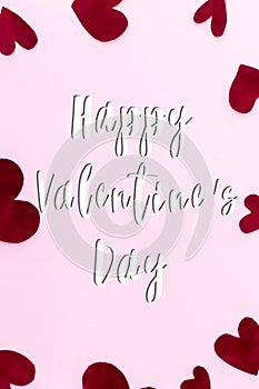 Happy Valentines Day greeting card. Happy Valentine`s Day text on stylish red hearts on pink background. Be my Valentine. Love